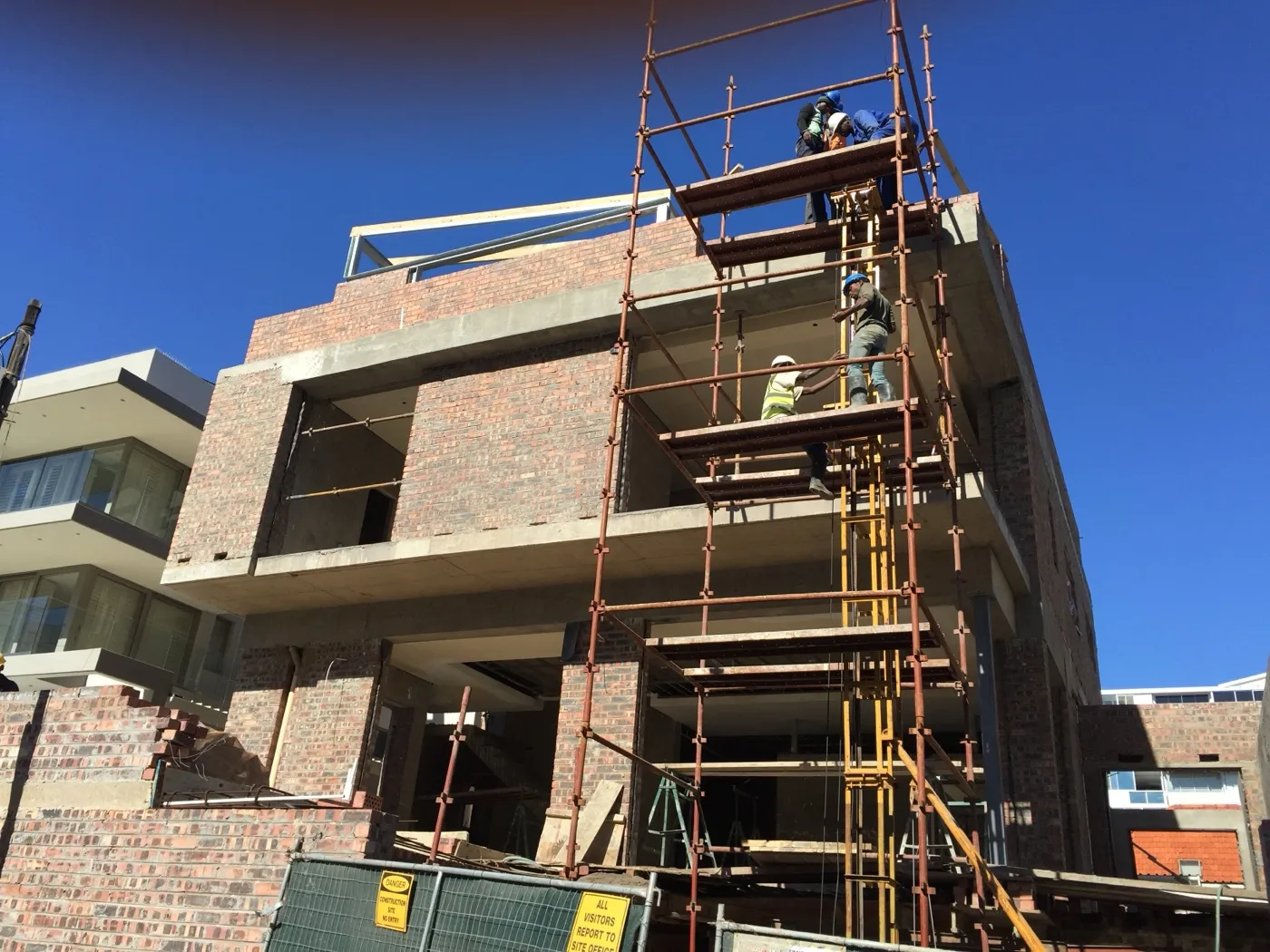 New home under construction with scaffolding on the upper floor