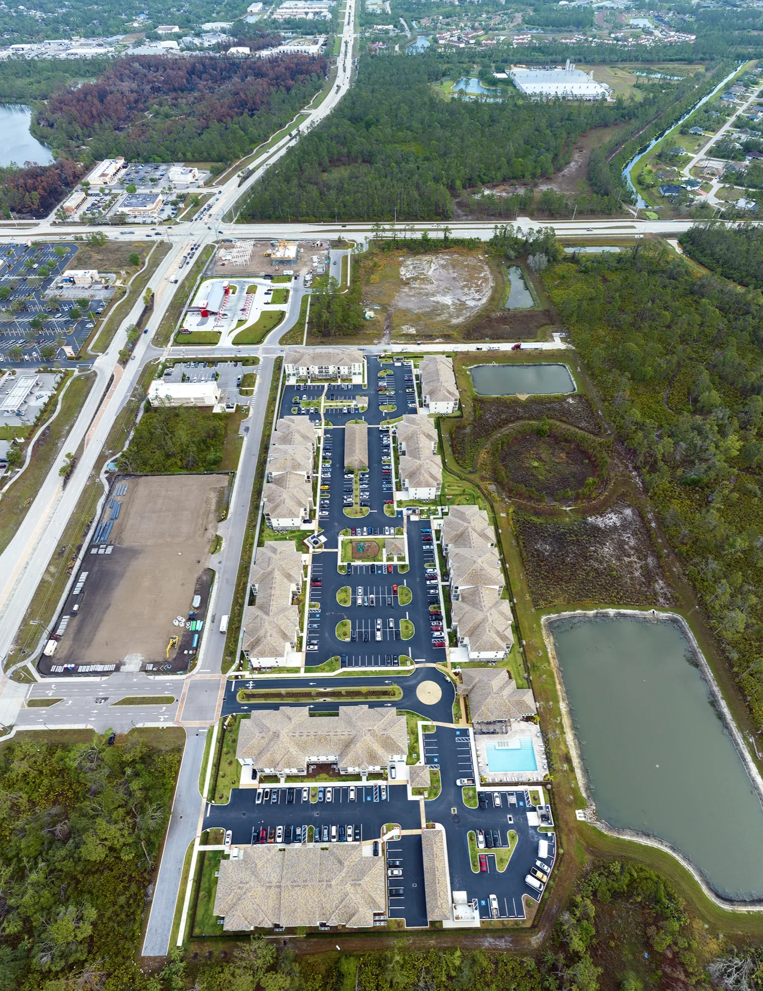 Aerial view of a Florida residential development beside a lake and open land